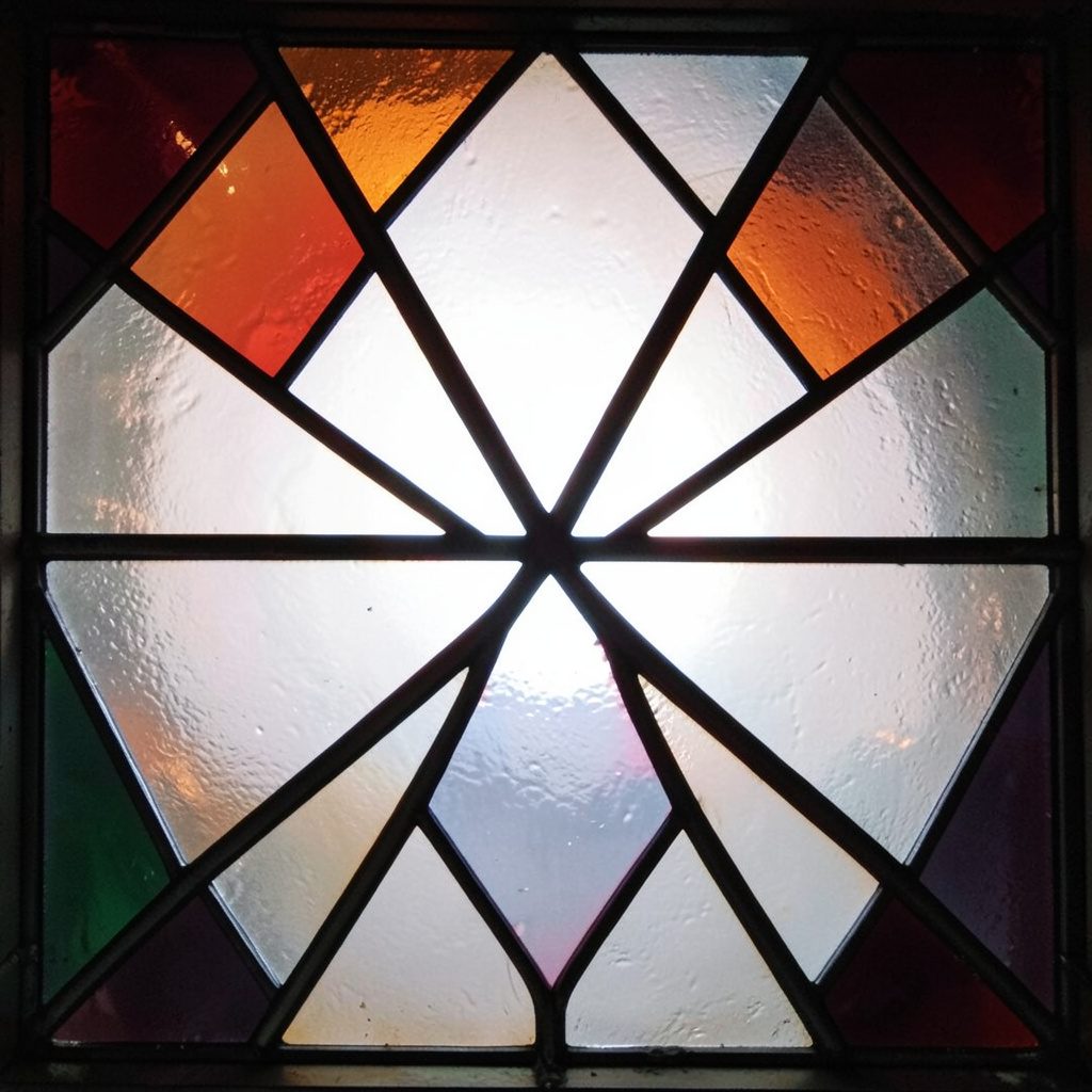 A stained-glass composition of concentric teal and emerald rings with bold black leading, a bright gold key-like shape at the center, suggesting structured data access.